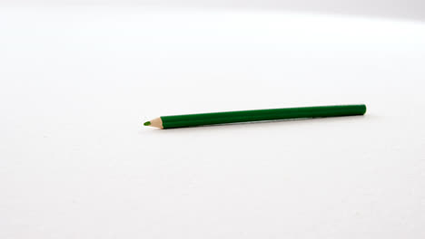 Green-pencil-falling-on-white-background