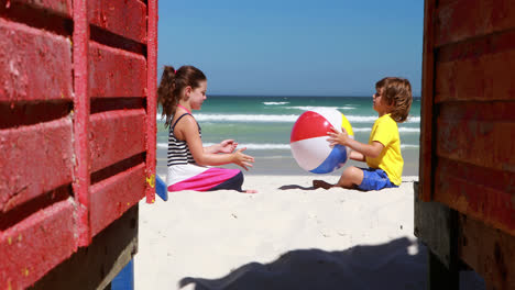 Siblings-playing-at-the-beach-on-a-sunny-day