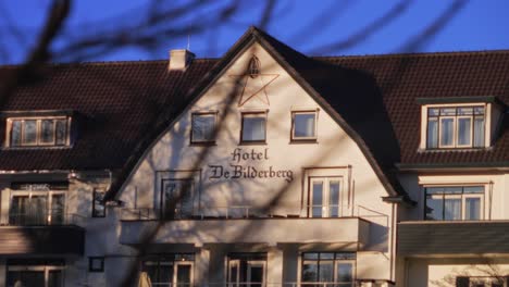 Fixed-facade-of-Dutch-historic-famous-Bilderberg-hotel-logo-through-trees