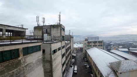 Aerial-view-of-abandoned-industrial-building-on-a-cloudy-moody-day-in-east-european-town