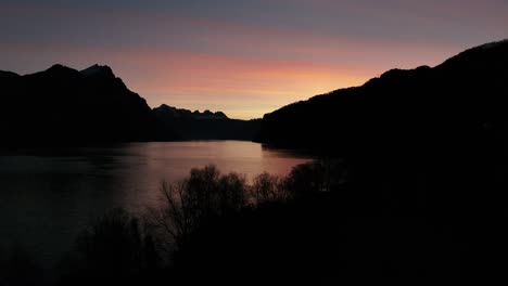 Twilight-serenity-on-Walensee,-Weesen-silhouette.-Switzerland-aerial