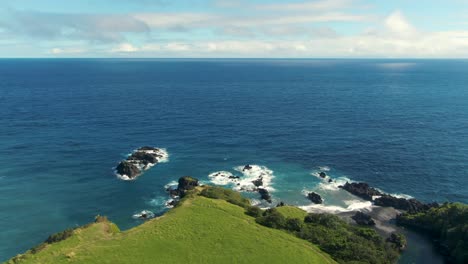 Pacific-ocean-horizon-and-Hawaii-island-with-Waioka-pond-area,-aerial-view