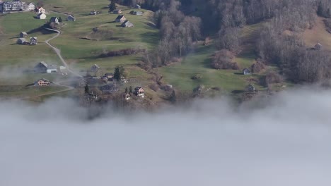 Misty-Amden-above-Walensee,-Switzerland---aerial-above-the-clouds