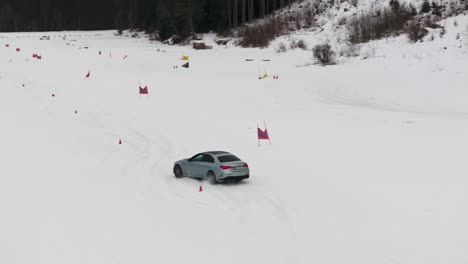 Car-drive-and-test-sharp-maneuver-tire-traction-on-snowy-drift-race-track