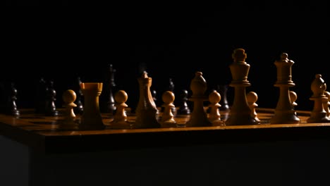 Cinematic-shot-of-chess-pieces-on-a-chessboard,-the-background-is-black-with-the-lightsource-coming-from-the-right
