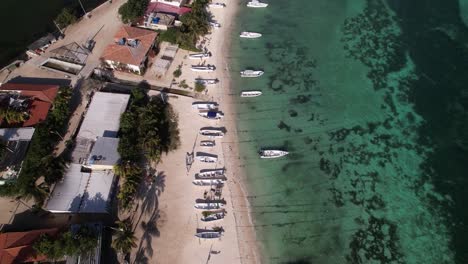 Aerial-Top-Down-View-Of-Beach,-tilt-up-reveal-Los-Roques-Airport,-coastline-caribbean-island