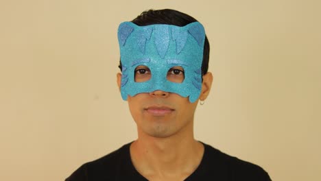 Latin-young-male-disguised-as-PJ-cartoon-with-a-children's-mask