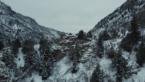 Revealing-Drone-Shot-Of-Rugged-Mountain-Scene-In-Winter,-FPV-Aerial-Flyover