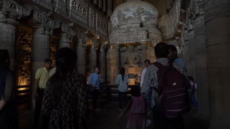 Tourists-taking-pictures-of-seated-Buddha-in-preaching-pose-inside-famous-Buddhist-caves-at-Ellora-caves