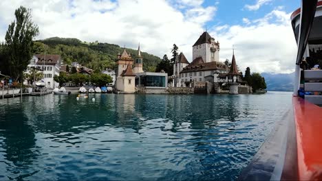 Switzerland,-Brienz,-February-10,-2024:-Trip-by-boat-along-buldings,-church-and-city-in-switzerland