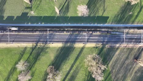 Aerial-View-of-train-crossing-Zug-Tracks-Idyllic-Switzerland-landscape