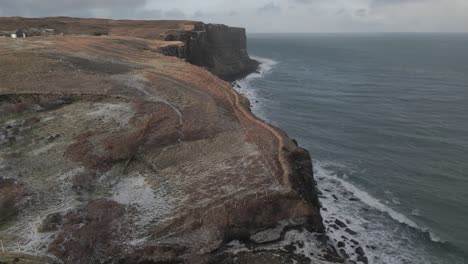 Kilt-rock-and-the-surrounding-sea-on-the-isle-of-skye,-with-a-focus-on-the-dramatic-cliffs-and-coastline,-aerial-view