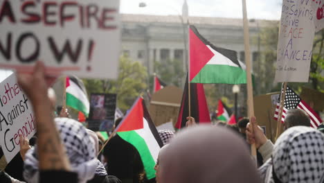 Pro-Palestine-Signs-and-Palestinian-Flags-Held-Above-the-Heads-of-a-Large-Crowd-of-Protestors-in-the-Streets