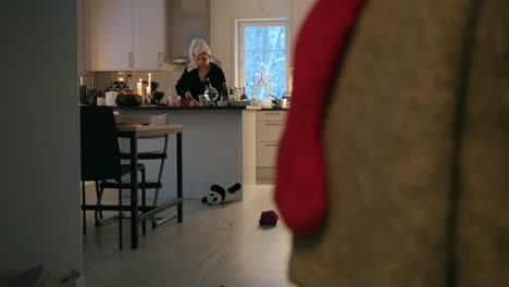 Woman-prepare-breakfast-for-family-early-Christmas-morning,-kitchen,-wide-shot