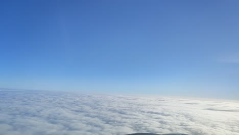 Cinematic-breathtaking-aerial-flying-backward-through-the-white-fluffy-clouds-high-in-the-heavenly-sky-with-fresh-clean-air-and-blue-skies-in-the-background