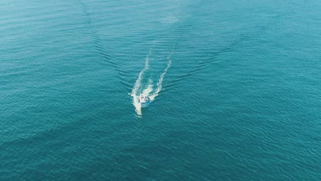 Drone-aerial-of-a-small-fishing-boat-heading-out-to-sea