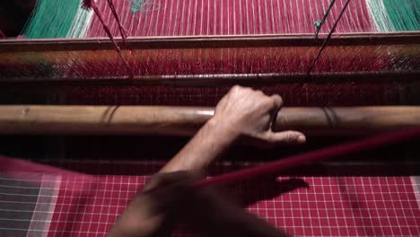 A-weaver-weaves-cloth-in-an-ancient-way