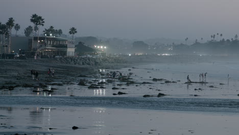 People-gather-on-the-beach-to-watch-the-"King-Tides'-in-Encinitas,-California