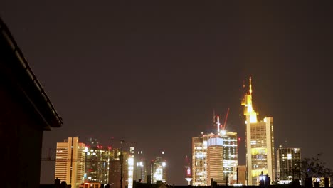 Twilight-view-of-Frankfurt-skyline-with-illuminated-buildings,-timelapse