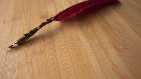 Feather-Pen-on-Wood-Background-Rotates