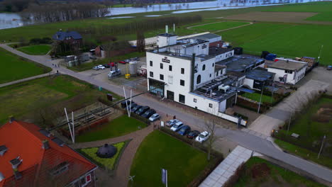 Tilt-down-drone-aerial-over-Hertog-Jan-famous-beer-brewery-in-Arcen-Limburg