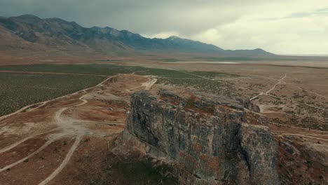 Aerial-descent-of-a-hill-formation-and-mountain-range