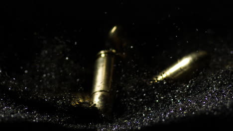 9×19mm-Parabellum-and-300-AAC-Blackout-bullets-falling-on-pile-of-gunpowder
