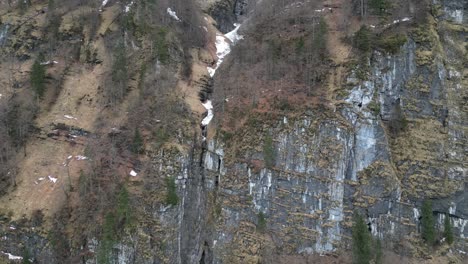 Klöntalersee-Switzerland-Glarus-rising-rotating-aerial-of-cliffs