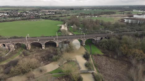 Aerial-view-of-Haversham-and-Little-Linford-viaduct-on-an-overcast-day-showing-local-flooding-from-River-Great-Ouse,-Milton-Keynes,-Buckinghamshire,-England