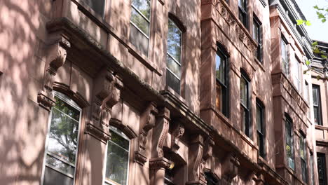 Tilt-up-view-of-Brownstone-Redbrick-Townhouse-in-Brooklyn-with-USA-flag
