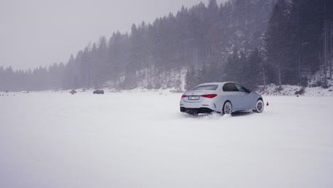 Car-slide-sideways-on-snowy-race-track-during-winter-drift-competition