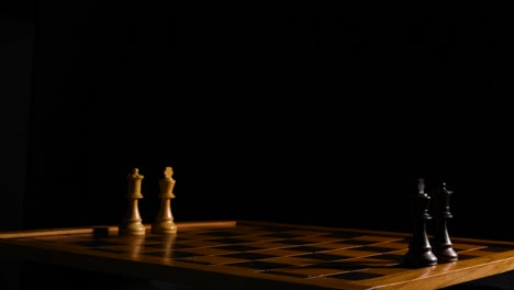 Cinematic-shot-of-a-chessboard-with-only-two-kings-and-queen-s-on-opposite-sides-of-each-other