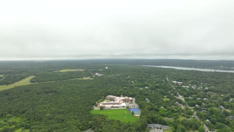 Drone-shot-of-rural-school-surrounded-by-forests-in-Massachusetts