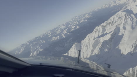 Light-passenger-aircraft-aerial-view-approaching-Sion-snow-covered-Swiss-mountains