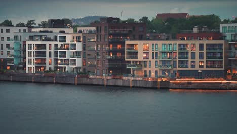 Modern-residential-buildings-with-brightly-lit-windows-in-the-coastal-quarter-of-the-Kristiansand-city