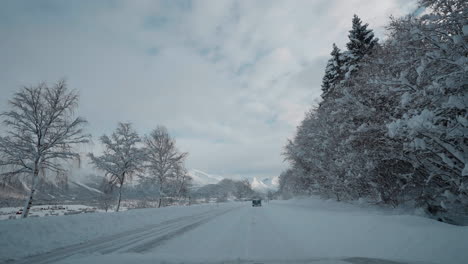 POV-video-of-driving-through-Norway's-Western-Fjords-in-winter,-showcasing-a-journey-along-snowy-roads
