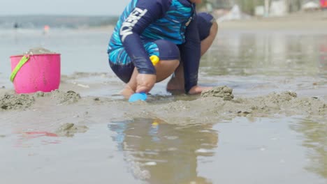 Two-Asian-children-playing-on-the-sand-at-a-beautiful-beach