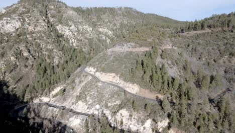 Switchback-road-with-cars-driving-on-Highway-89-A-in-Sedona,-Arizona-with-drone-video-moving-in-a-circle-wide-shot