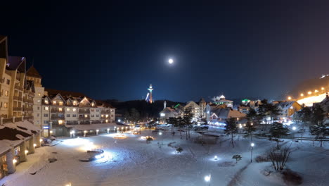 InterContinental-Hotel-and-Illuminated-Winter-Olympic-Village-In-Moonlight-at-Alpensia-Pyeongchang-Resort,-Night-time-lapse
