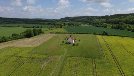 Aerial-orbiting-small-chapel-in-country-fields-summer-UK