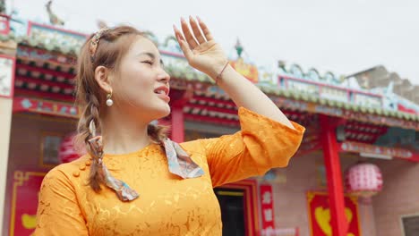 Close-up-of-an-Asian-girl-in-national-costume-walking-to-visit-a-pagoda