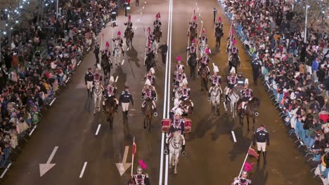 Participants-riding-on-horses-at-the-Three-Wise-Men-festival,-also-known-as-the-Three-Kings-Parade,-join-families-and-spectators