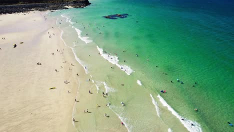 Porthmeor-Beach-in-St-Ives-with-Tourists-Enjoying-the-Turquoise-Waters-Along-the-Cornish-Coastline-During-Summer
