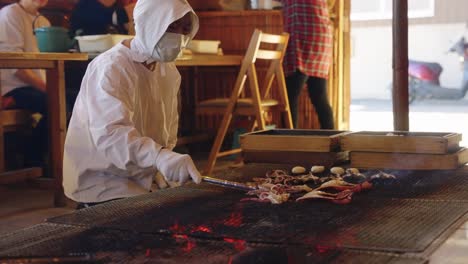 Smoke-and-Flames-over-Grill-as-Squid-are-flipped-in-Slow-motion