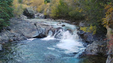 Marble-Crystal-Mill-Colorado-scenic-aerial-drone-cinematic-fall-autumn-Southern-Colorados-late-afternoon-sunset-cloudy-shaded-down-the-river-waterfall-drop-landscape-pan-reveal-backwards-movement