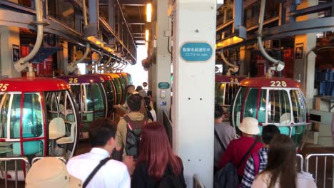 People-stand-in-line-waiting-to-go-on-the-summit-cable-car-in-Ocean-Park,-Hong-Kong