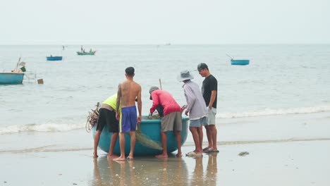 A-group-of-fishermen-are-bidding-for-a-fresh-catch-of-fish-just-caught-offshore
