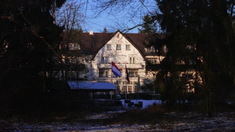 Historic-and-famous-Bilderberg-hotel-seen-from-forest-hidden-in-between-trees
