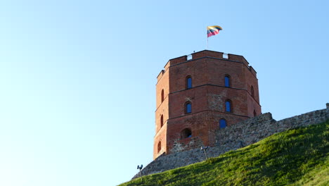 Lithuanian-flag-flying-above-Gediminas-castle-tower,-Vilnius,-Lithuania-fort