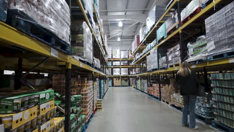 POV-Walking-Past-Female-Shopper-Searching-For-Item-At-Costco-Hayes-Branch